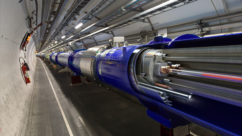 A diagram of the LHC superimposed on a photo of its beamline
